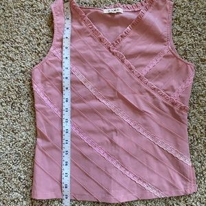 Cute pink sleeveless blouse with ruffle and lace details in front
